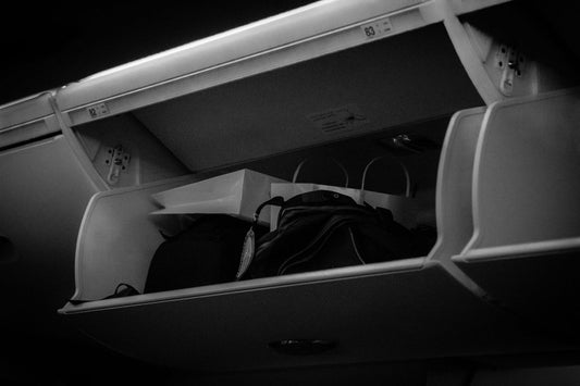 Airplane overhead storage bin with cabin luggage inside